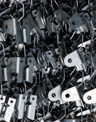 Industrial metal parts on a powder coating line - Preparing for high performance finishing and corrosion resistance - serving greater houston at axys industries